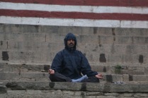 indian man meditating in Varanasi, India