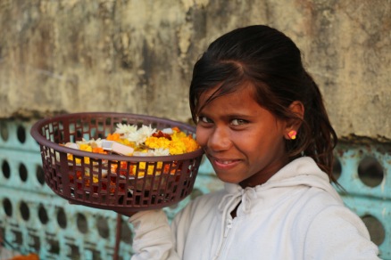 Indian child selling flowers in Rishikesh, India