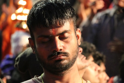 indian man meditating in Rishikesh, India