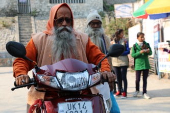 Indian sadhu with motorbike in Rishikesh, India